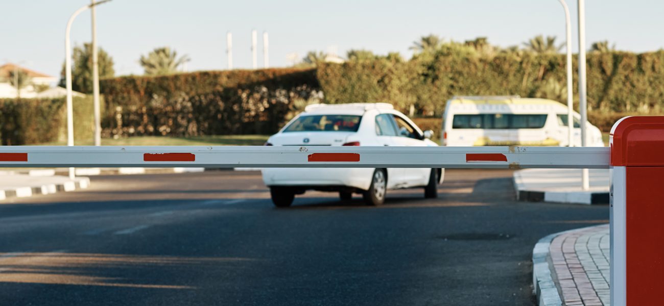 Guarded entrance to the territory with automatic barrier Checkpoint with security and automatic barrier on street. Guarded entrance to the territory